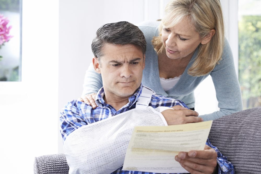 An injured man reading a request for medical records from the insurance company.