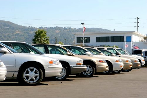cars lined up in a car lot