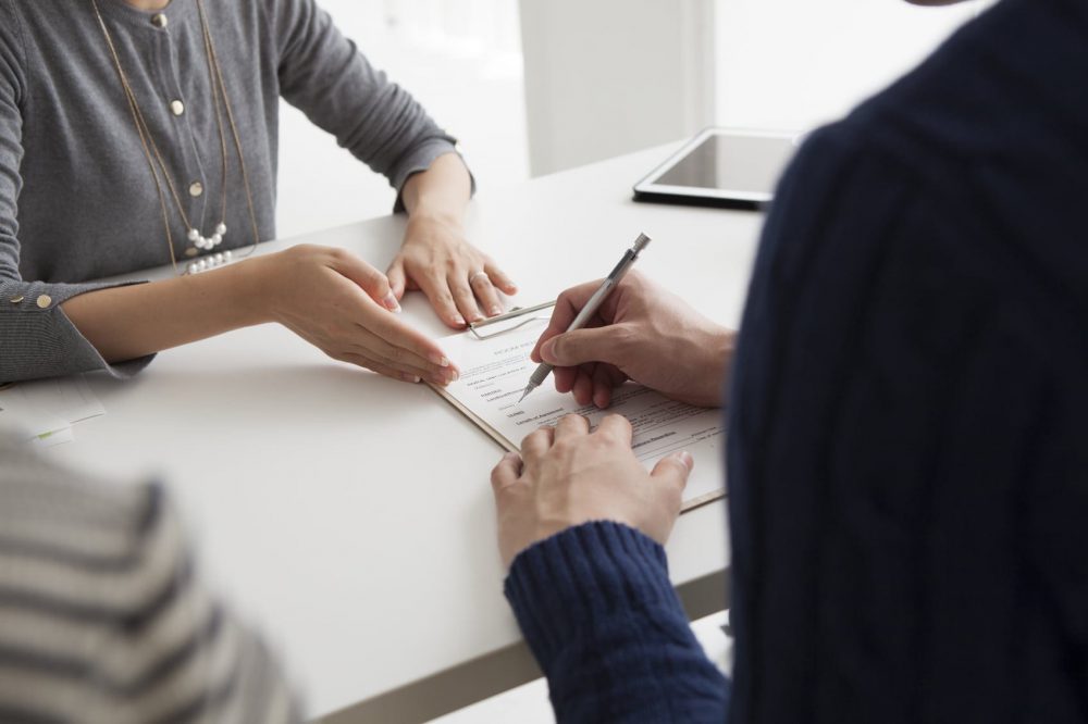 Woman Signing A Contract Or Legal Document Stock Photo