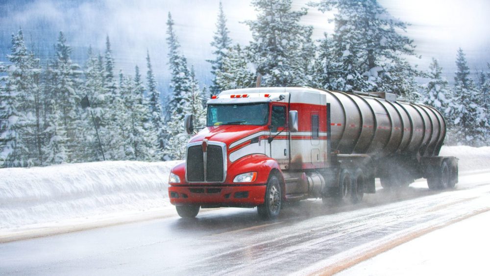 Large Semi-truck Driving On An Icy Road Stock Photo
