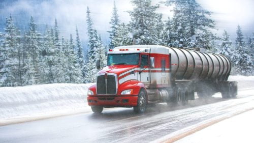 Large Semi-truck Driving On An Icy Road Stock Photo