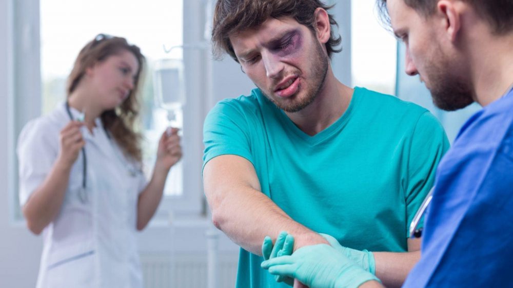 Injured Man Being Examined By A Male Nurse Stock Photo