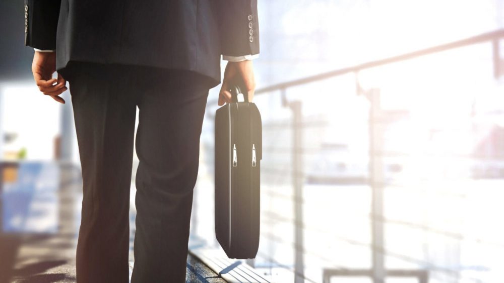 Businessman Walking With A Briefcase Stock Photo