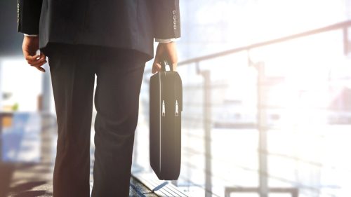 Businessman Walking With A Briefcase Stock Photo