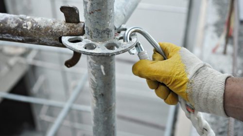 Construction Worker Working On Scaffolding Stock Photo