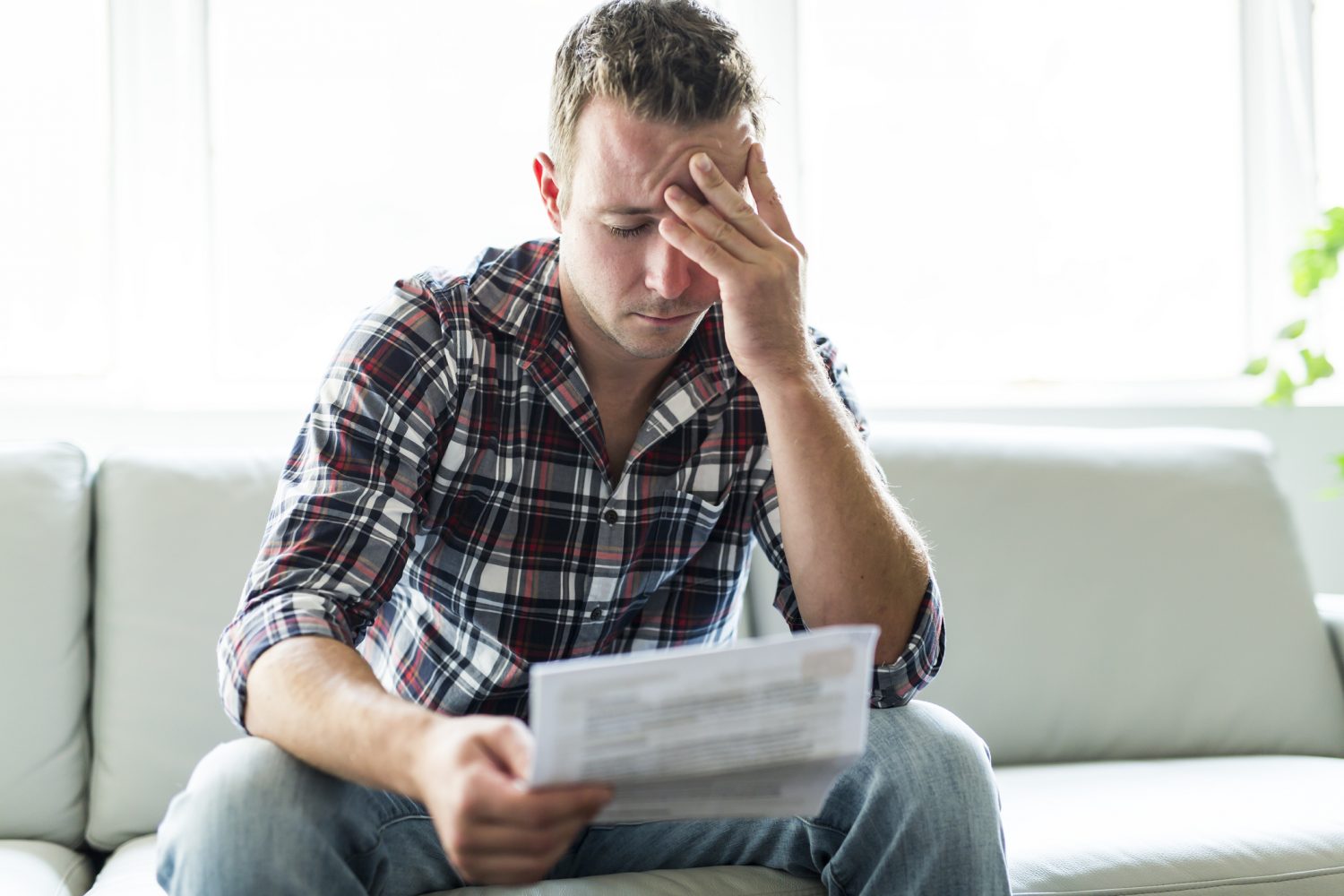 A Fort Wayne, IN, man reading his medical bills after an accident