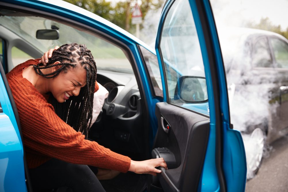 A woman experiencing pain after a car accident.