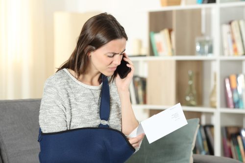 A woman looking frustrated about her injury case.