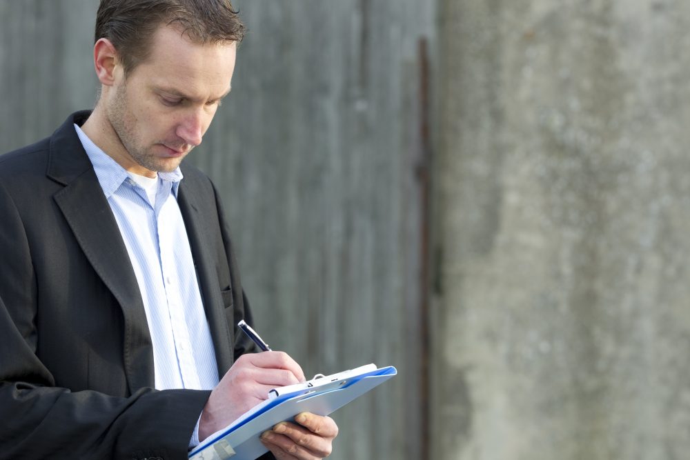 A claims adjuster from an insurance company reviews evidence from a personal injury claim.