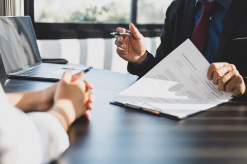 Client consulting a personal injury lawyer in their office.